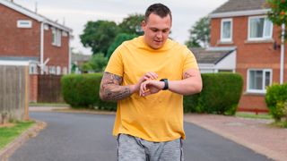 Man looks at running watch