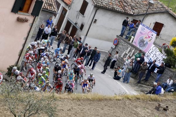 The peloton races through a town on stage 13