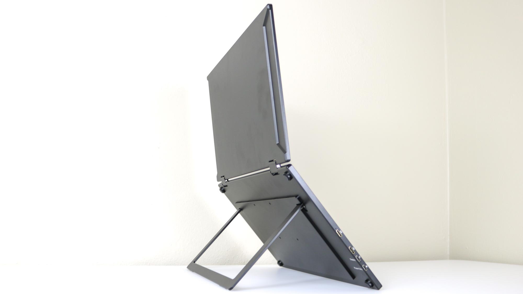 The UPERFECT UStation Delta dual-screen portable monitor standing up on a desk using its built-in stand