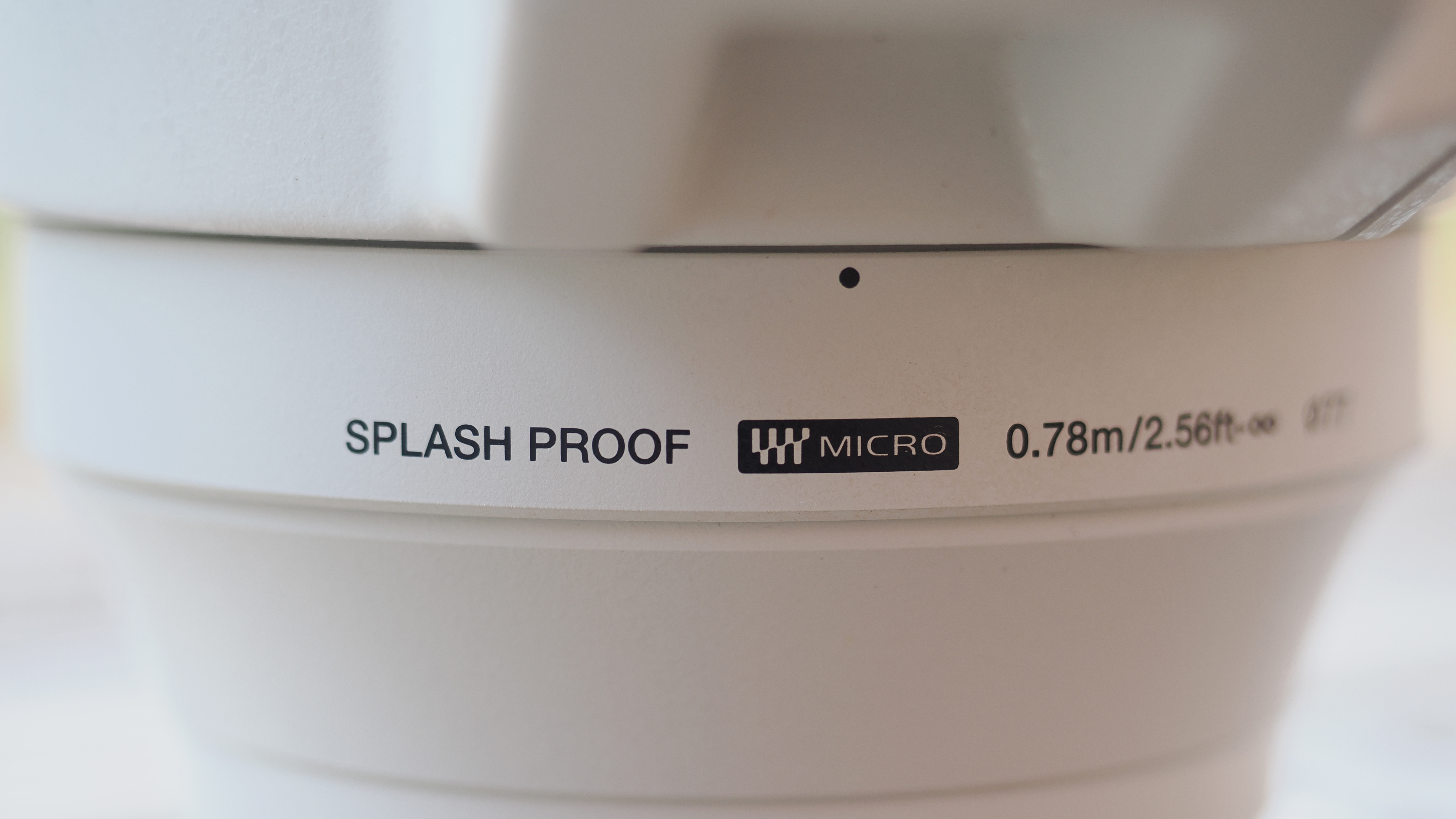 The OM System M.Zuiko 50-200mm f/2.8 IS Pro lens, mounted to the OM System OM-1 Mark II, in an outdoor setting