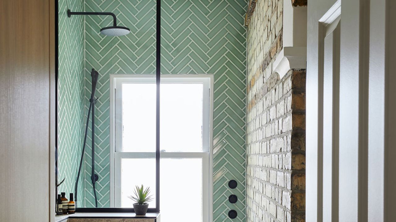 Green tiles with black shower head