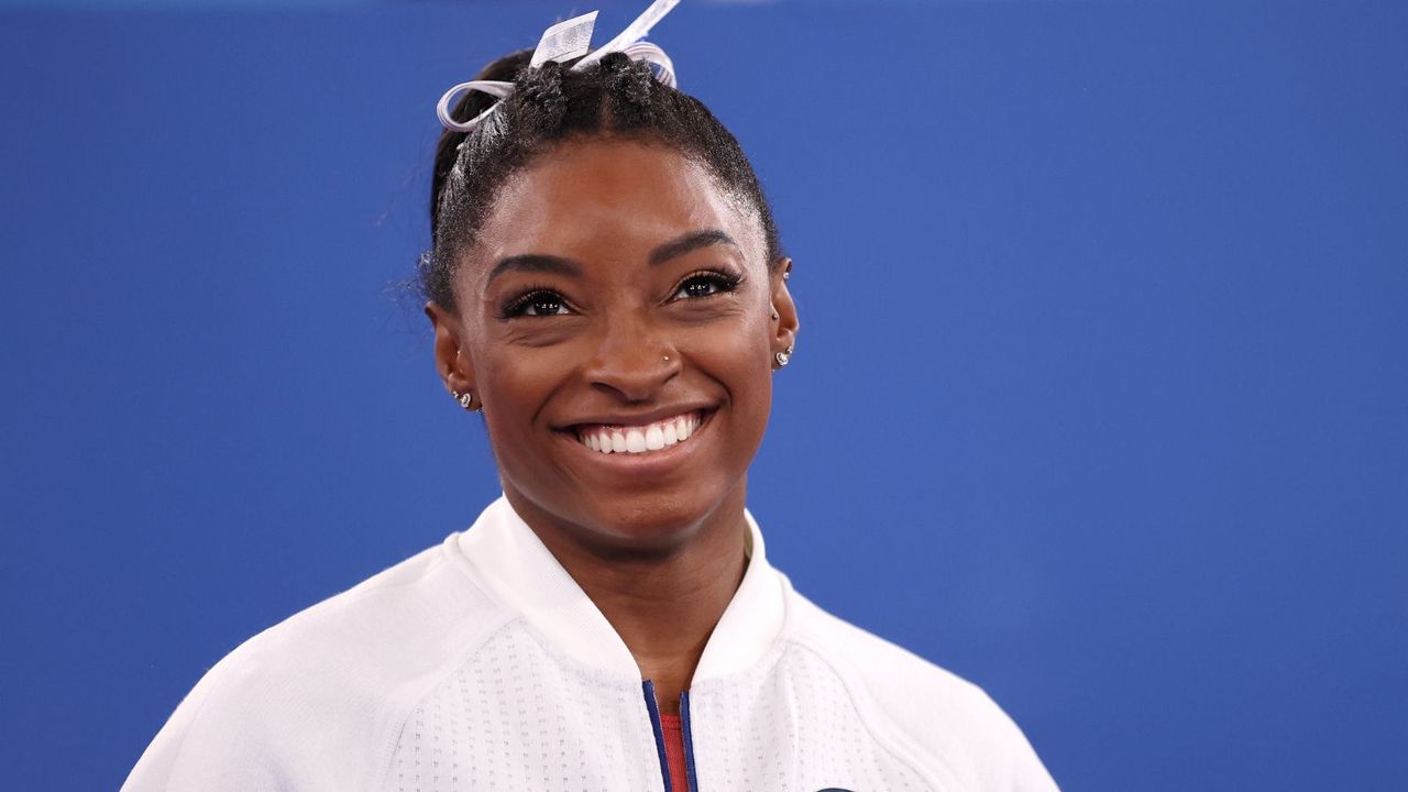 simone biles on a blue background