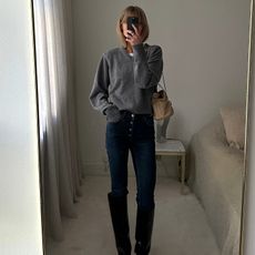 Jeanette Madsen in a grey sweater and Prada bag