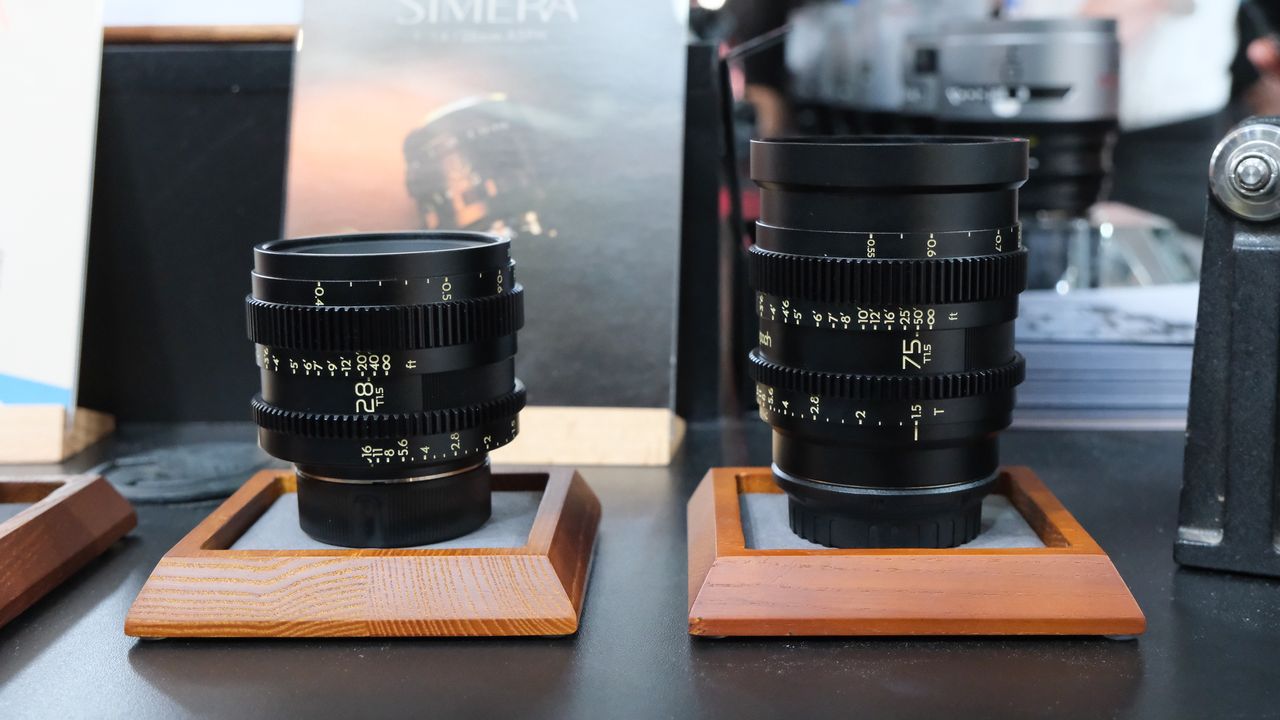 Thypoch Simera-C cine lenses next to one another on wooden display platforms on a black table