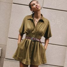 Anthropologie model looking up wearing suede green tobie mini dress