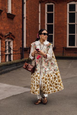 woman wearing black button down shirt and floral skirt