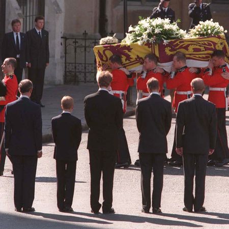 Earl Spencer, Prince Harry, Prince Philip, Prince WIlliam and Prince Charles standing in front of Princess Diana's coffin with their backs to the camera