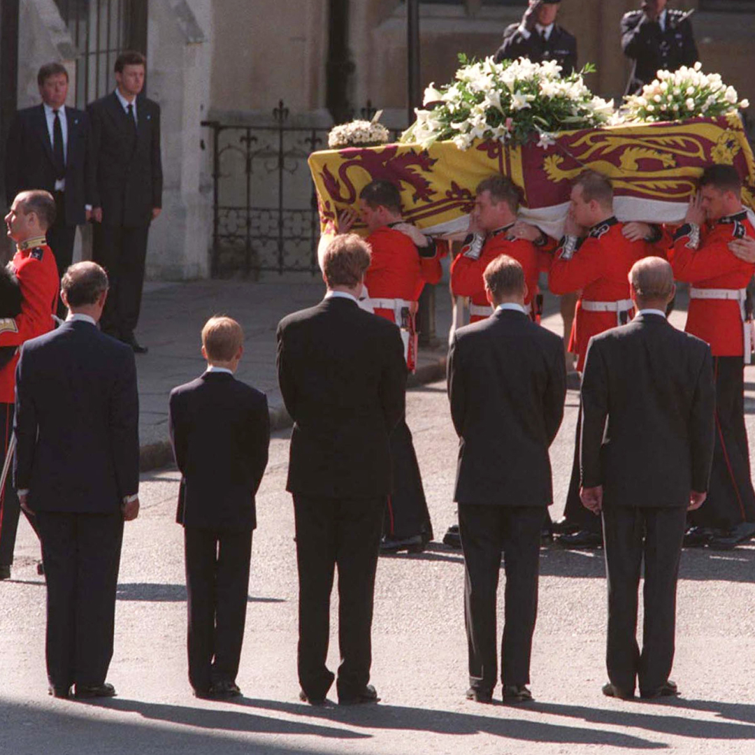 Earl Spencer, Prince Harry, Prince Philip, Prince WIlliam and Prince Charles standing in front of Princess Diana's coffin with their backs to the camera