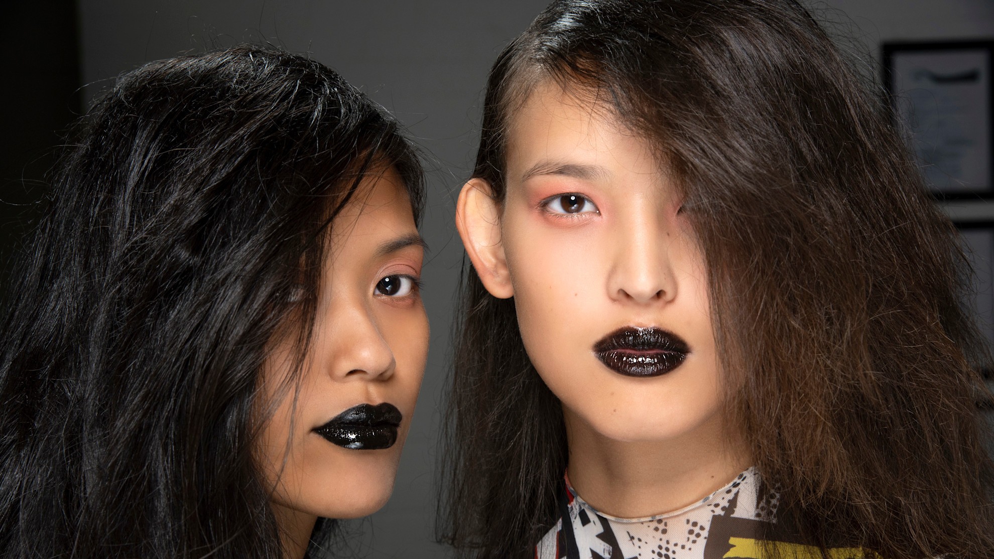 two models wearing black lipstick