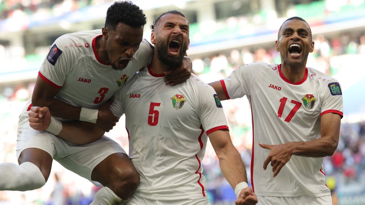 Jordan&#039;s defender #03 Abdallah Nasib, defender #05 Yazan al-Arab, and defender #17 Salem al-Ajalin celebrate after South Korea conceded an own goal during the Qatar 2023 AFC Asian Cup Group E football match between Jordan and South Korea at the Al-Thumama Stadium in Doha on January 20, 2024.