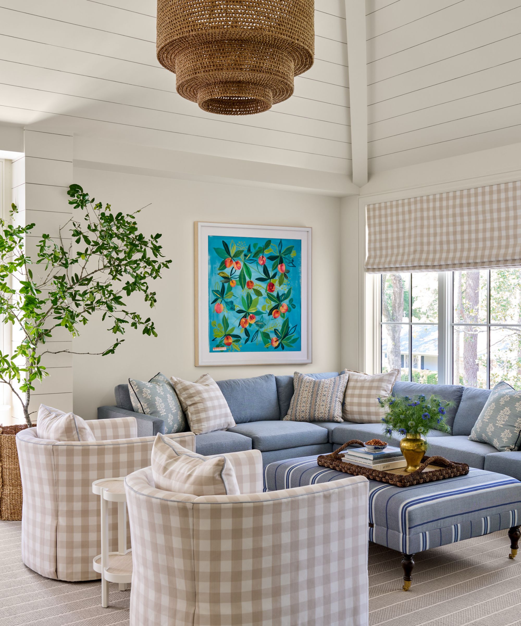 Beach house interior with gingham chairs and blind by Katie Davis Design