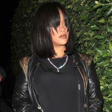 Rihanna wore an extra-long black leather trench coat with her Gucci horsebit bag