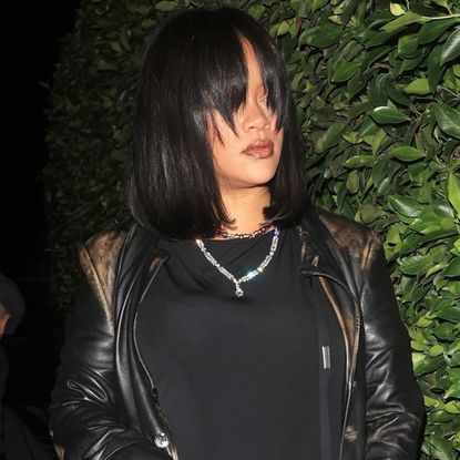 Rihanna wore an extra-long black leather trench coat with her Gucci horsebit bag