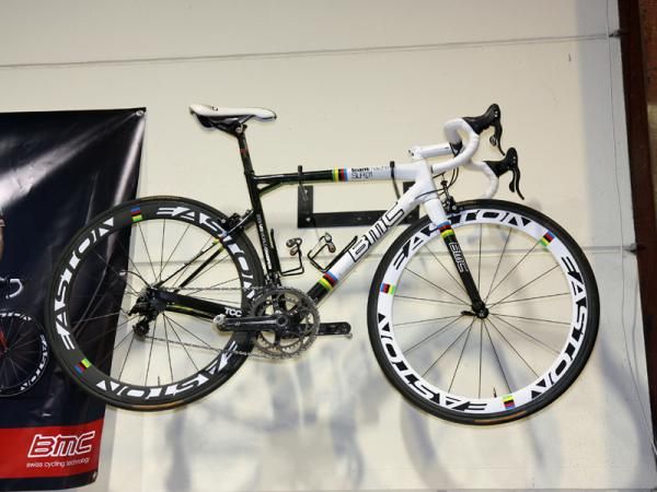 The mechanics' area of the BMC service course is decorated with one of Cadel Evans' world championship bikes on one side of a big banner&hellip;
