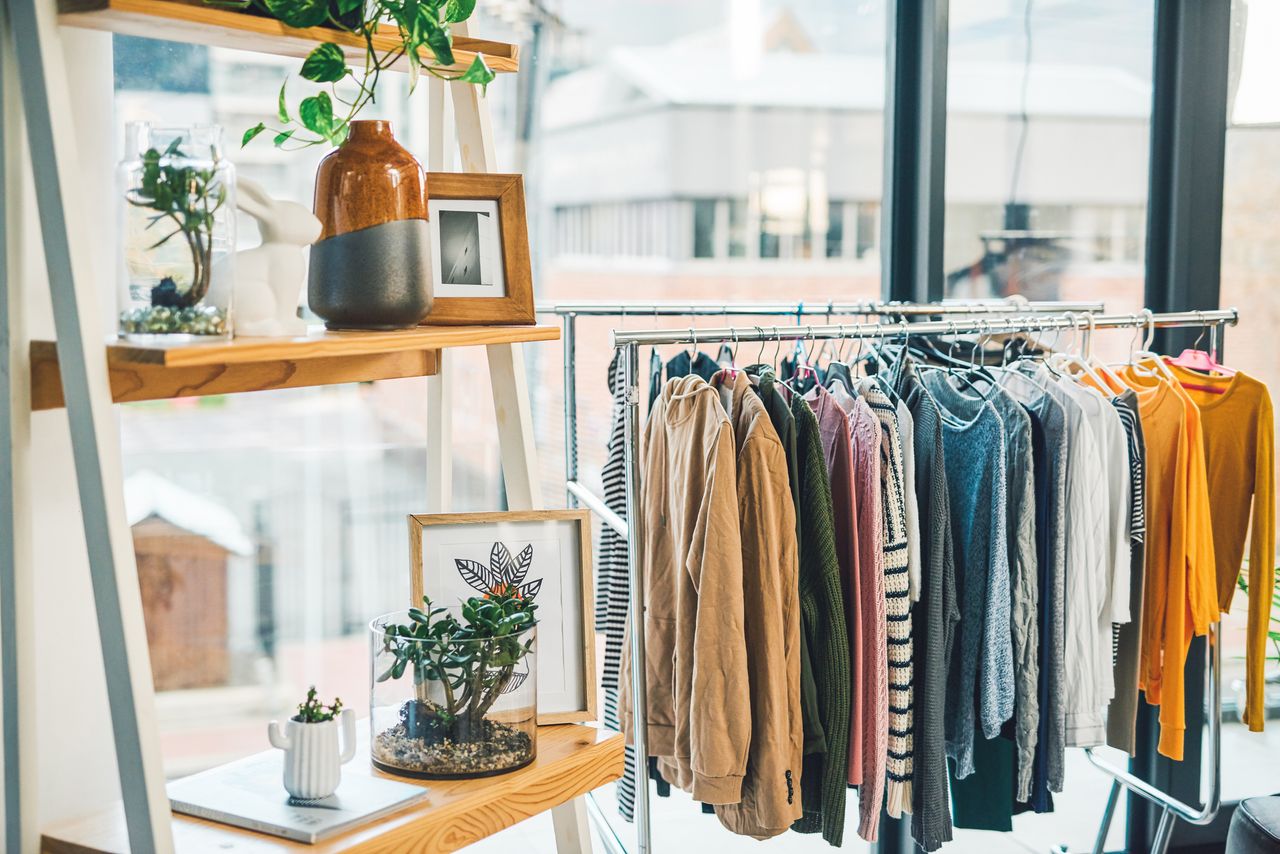 Shot of clothing hanging on a rack in an empty boutique