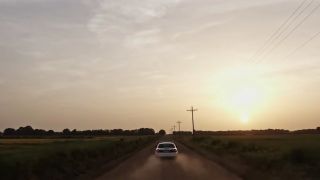 A police car driving in Murder in the Bayou