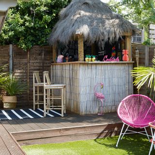 Tiki bar on raised decking area in garden