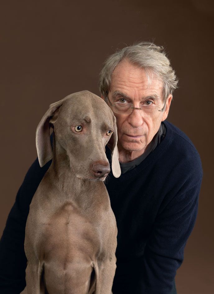 A portrait photo of a man with a dog 