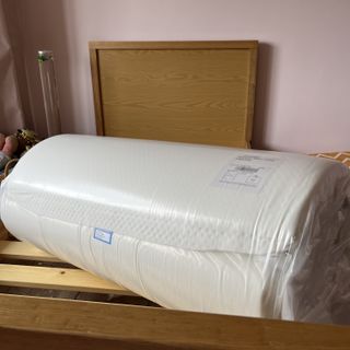 rem-fit kidz mattress rolled up on bed