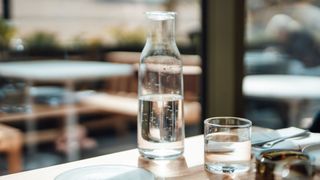 Bottle of water and glass with water on a table