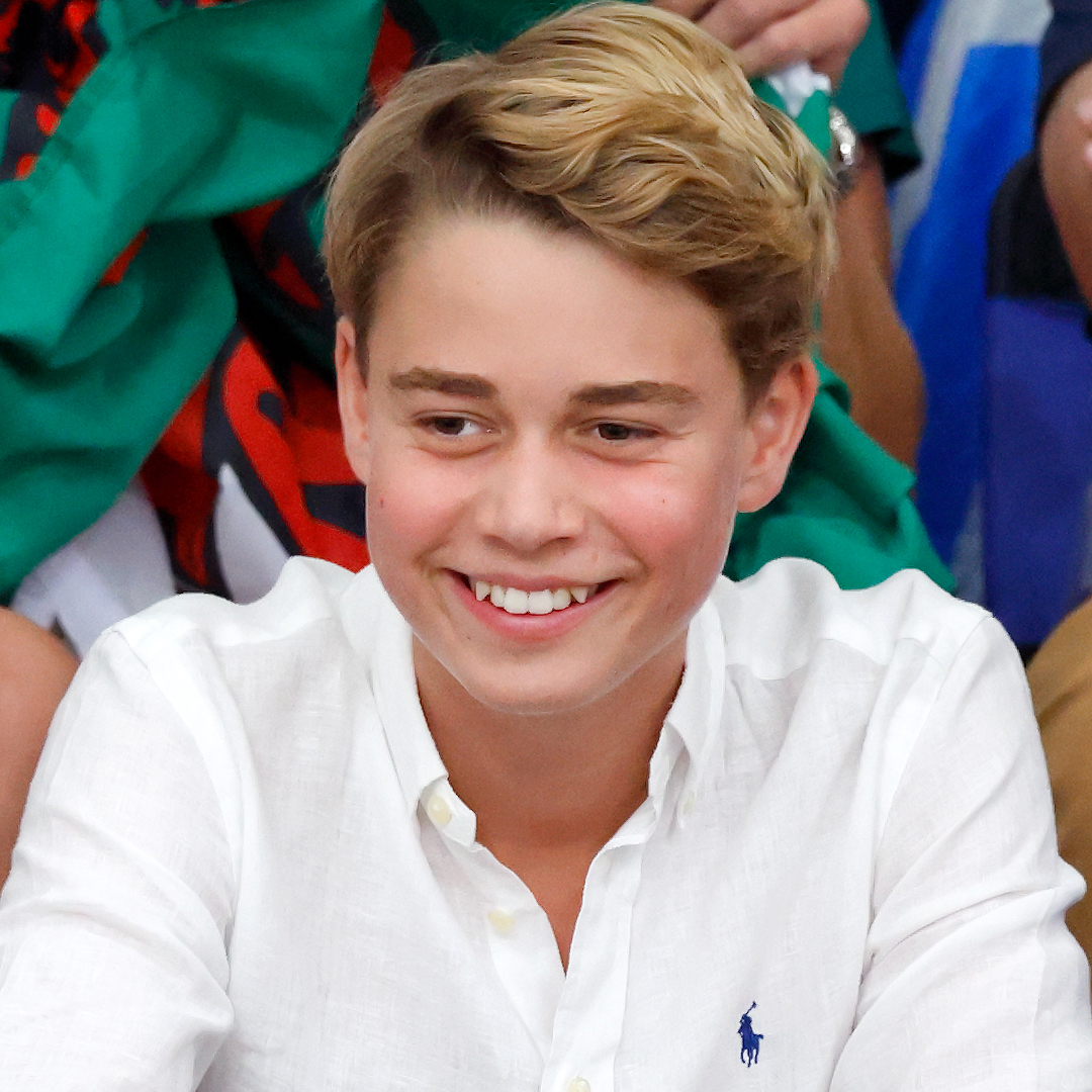 Prince George smiling in a white button up shirt