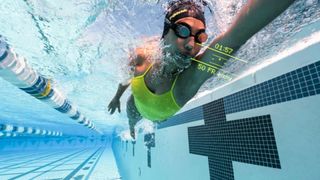 Woman swimming in pool using HeadCoach swimming app