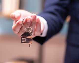 Real estate agent holding home keys