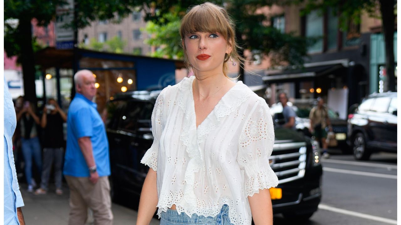 Taylor Swift spotted out in New York wearing Free People denim mini skirt and white blouse from Dôen. 