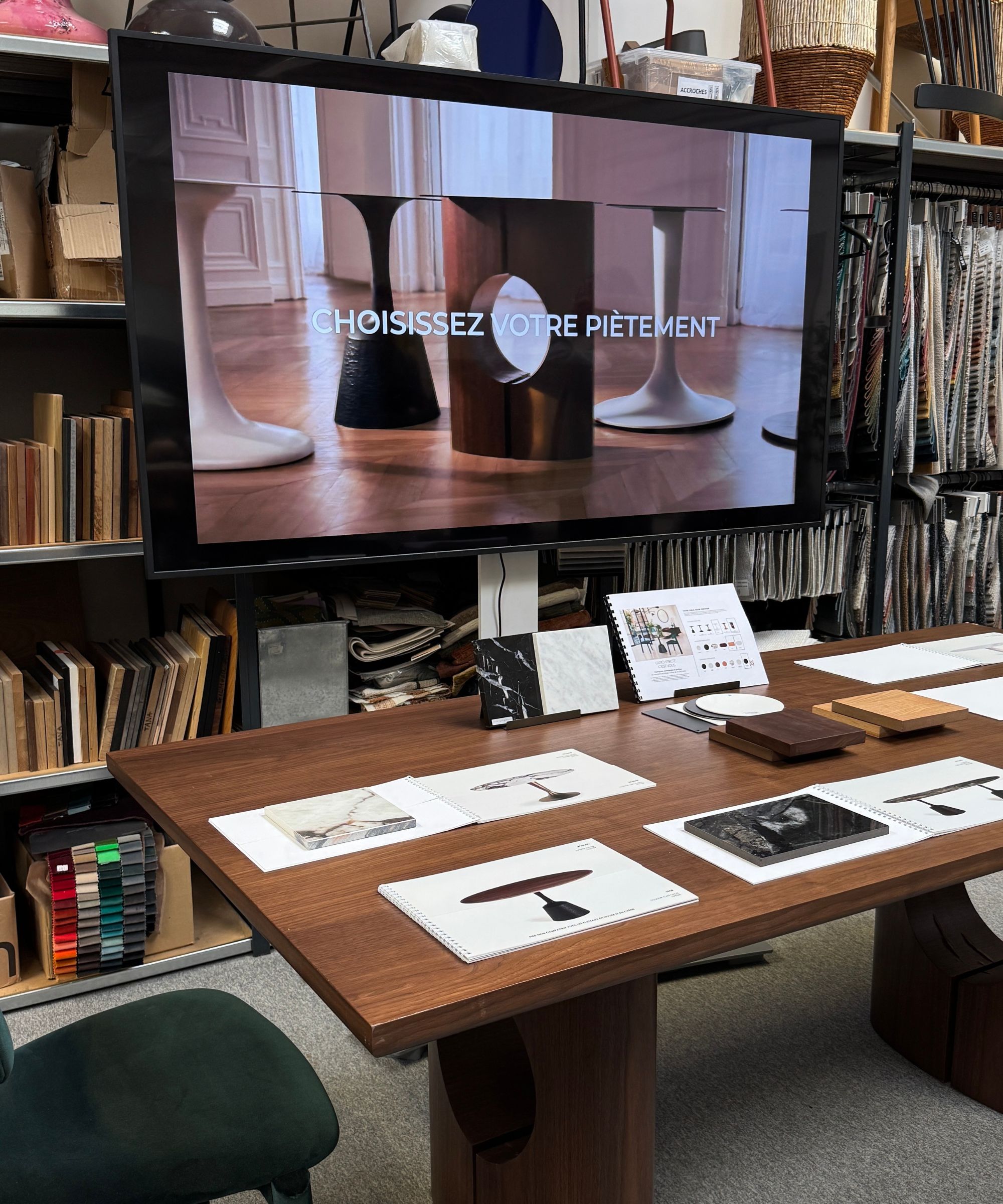 AM.PM custom dining table system with TV screen showing the bases