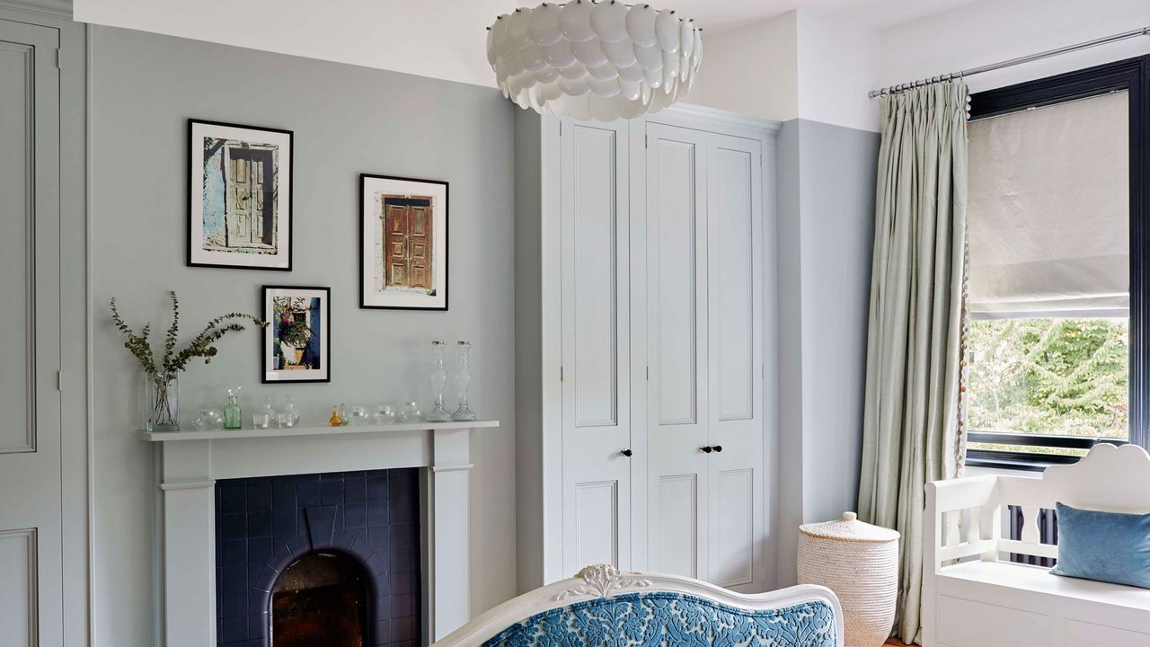 Blue bedroom with fireplace and wardrobes