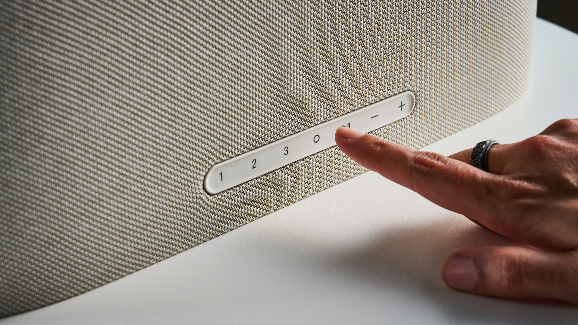 the denon home 600 home speaker photographed with the blue tom's guid e background