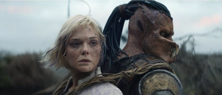 Elle Fanning as Thia and Dimitrius Schuster-Koloamatangi as Dek back to back with each other in Predator: Badlands
