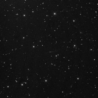 Comet 209P/LINEAR appears as a dim, dusty object at the center of this photo taken by NASA astronomers at the Marshall Space Flight Center in Huntsville, Ala. in May 2014. Dust from the comet is expected to create a meteor shower that will be first seen on Earth in May 2014.