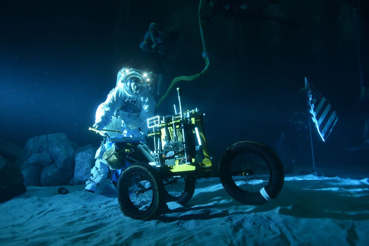 Experiments are ongoing to transform part of the Neutral Buoyancy Laboratory, a pool facility used by NASA for International Space Station spacewalks, into a practice zone for moonwalks. The underwater work is early-stage, but is working with prototypes of spacesuits and hardware, along with sand and landscape features like elevation.