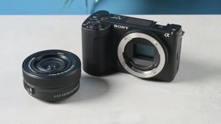 A black Sony ZV-E10 II compact and portable vlogging camera sitting next to an E PZ 16-50mm F3.5-5.6 OSS II kit lens