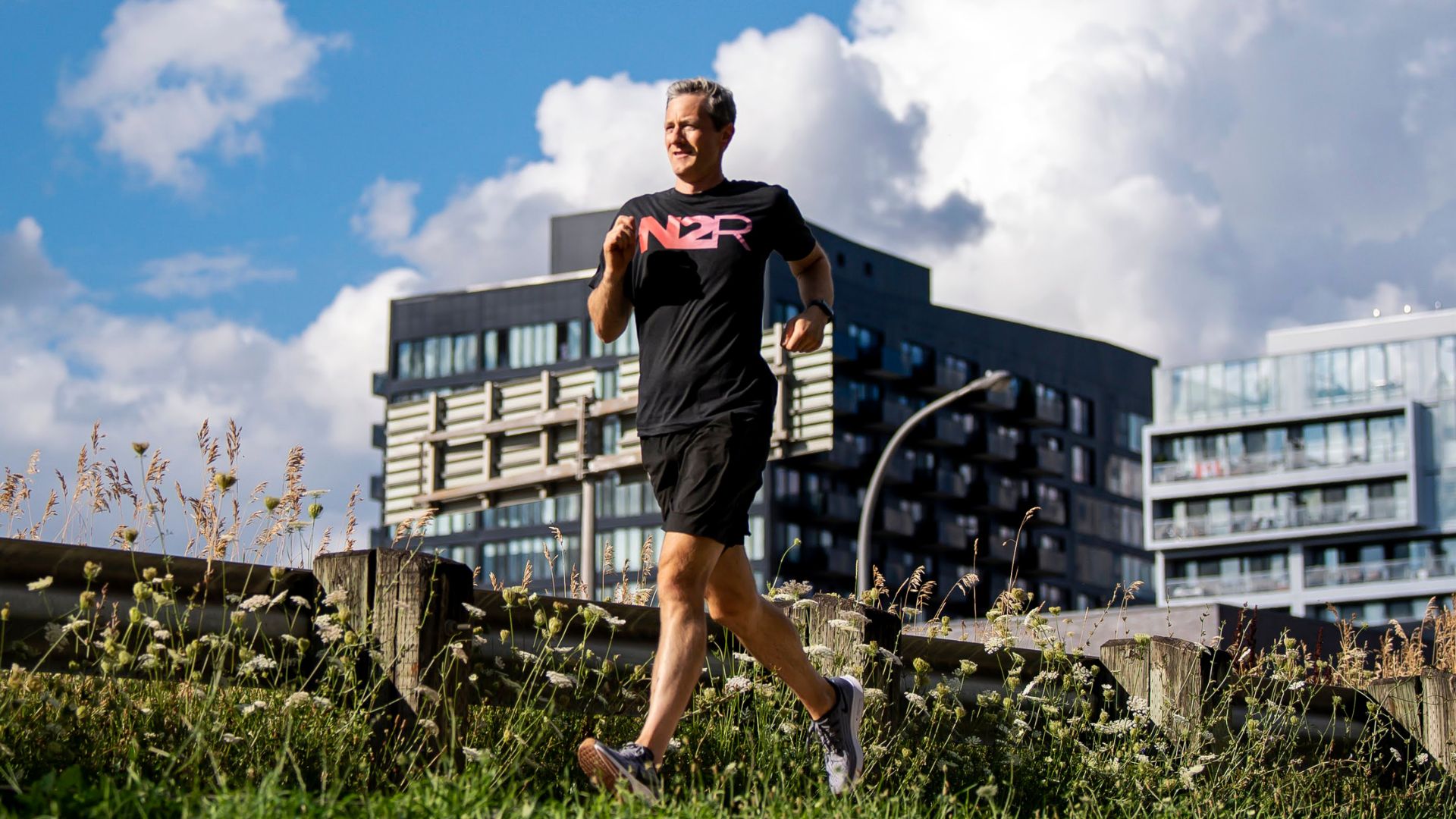Man runs outside in long grass