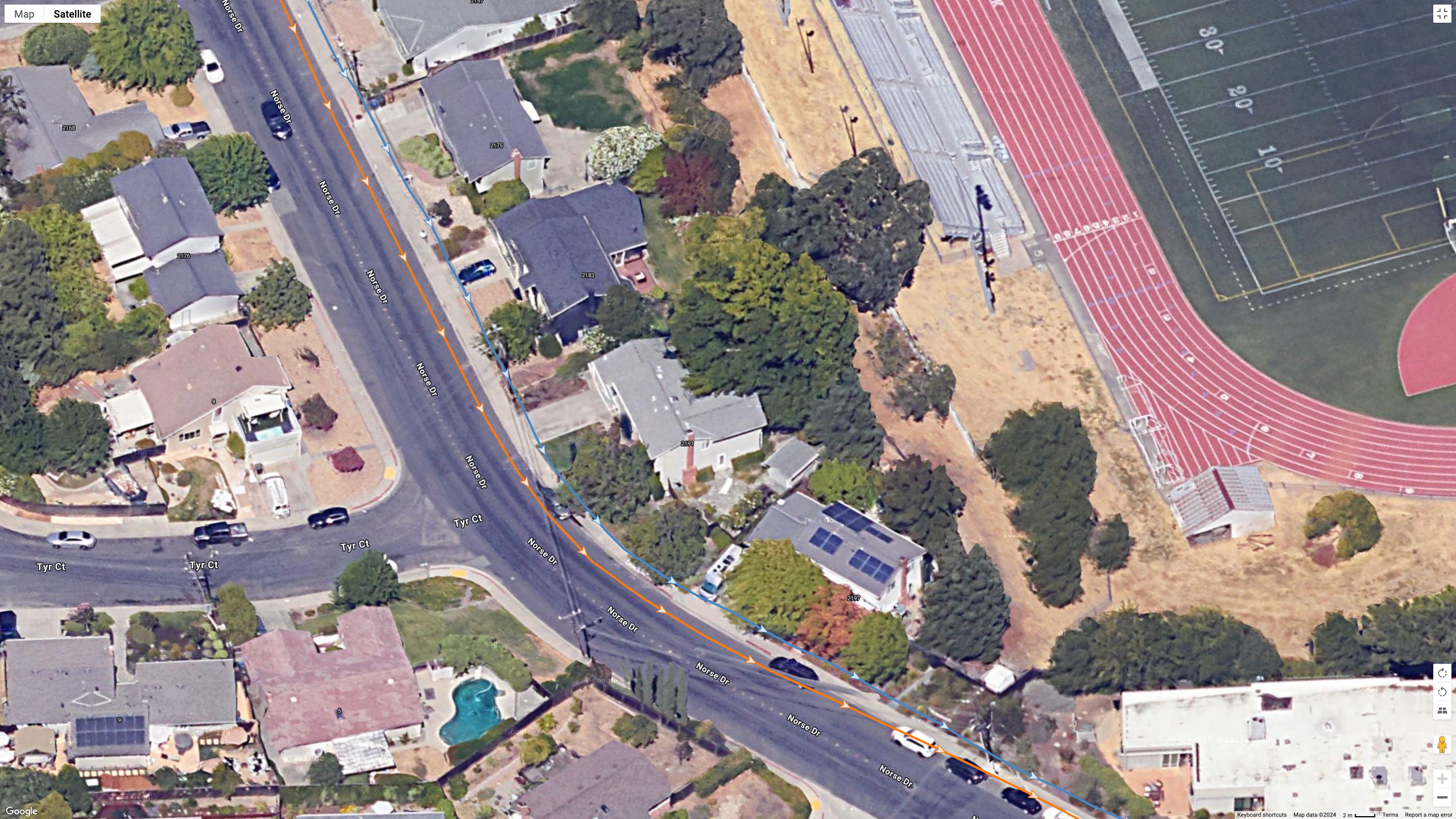 A Google Earth satellite image showing a runner's location data, comparing the COROS PACE Pro (orange) and Garmin Fenix 8 (blue) for multi-band GPS accuracy.