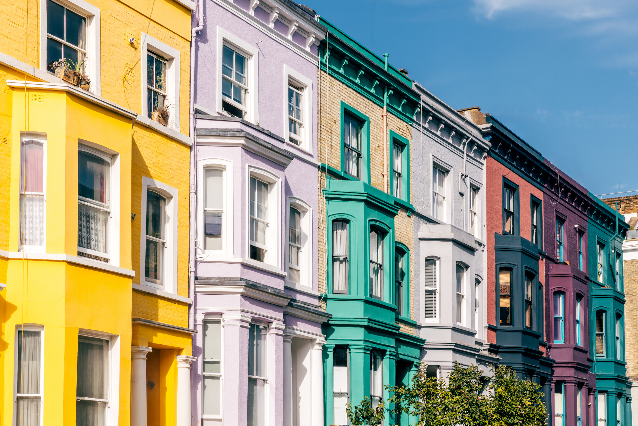 Multi-coloured vibrant row houses in Notting Hill on a sunny day, London, England, UK.