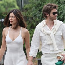 Monica Barbaro and Andrew Garfield arrive at All England Lawn Tennis and Croquet Club for Wimbledon wearing all-white matching outfits on July 06, 2025 