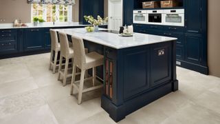 large navy kitchen island with white composite worktop