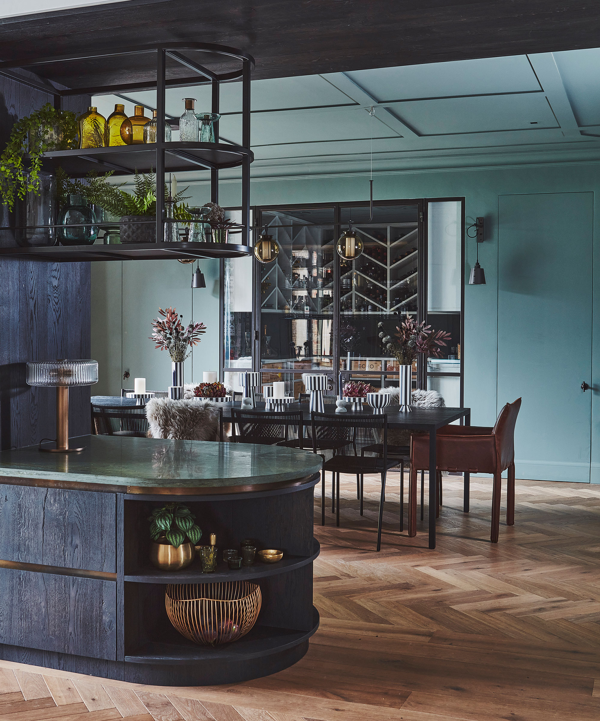 blue kitchen diner with herringbone wooden flooring