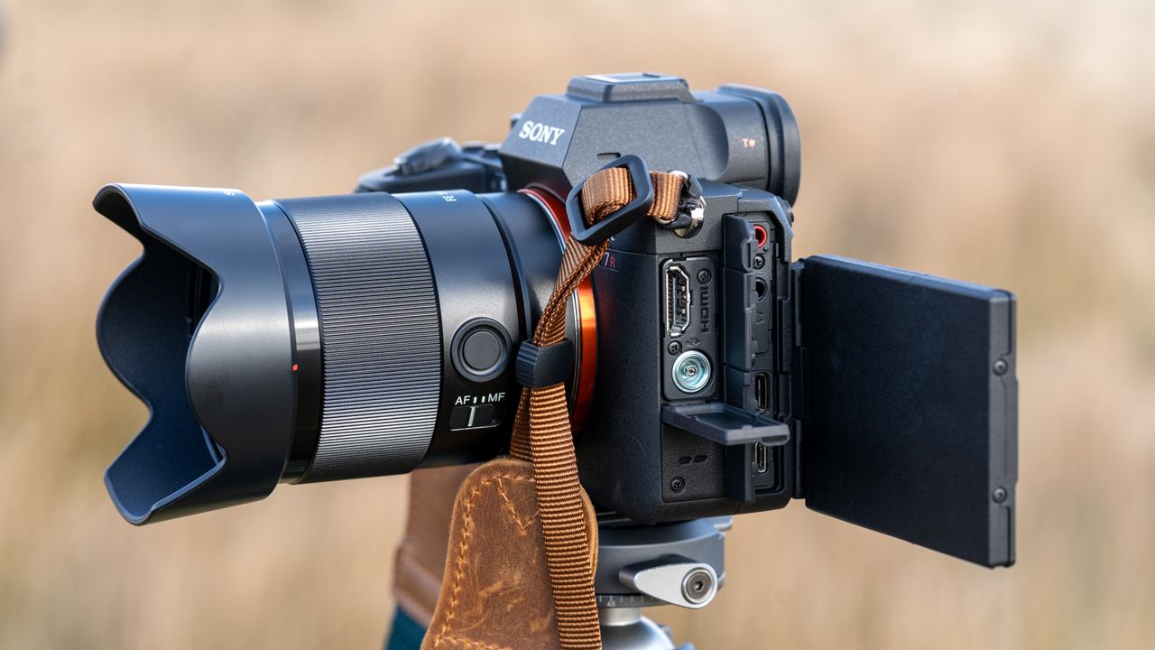 Sony A7R V on a tripod with port doors open and screen flipped out