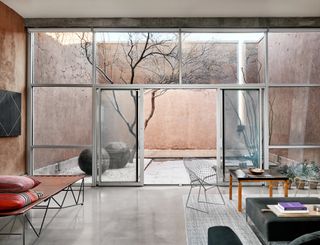 Glazed facade with views to a courtyard at house in Marfa
