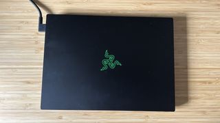 Razer Blade 14 with lid closed on a wooden desk