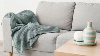 A gray blanket on a couch