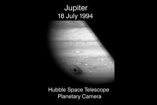 Jupiter as seen by Hubble's Planetary Camera on July 18, 1994, showing the impacts of Comet P/Shoemaker-Levy 9's fragments on the surface.