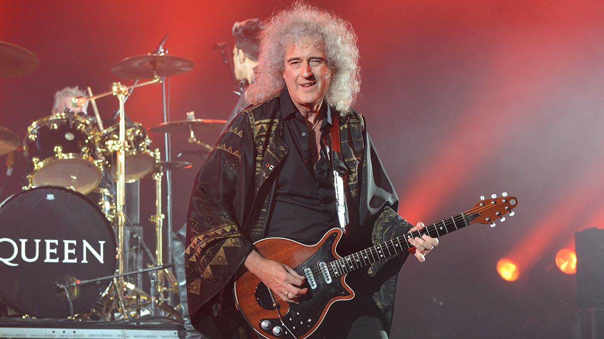 Brian May playing live onstage with Queen + Adam Lambert