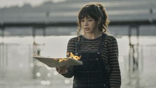 Jos Clearly-Lopez holds a flaming book in Prime Video's The Power