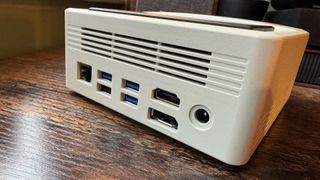 AyaNeo Retro Mini PC AM01 on a wooden home office desk