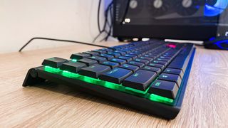 Cherry MX 10.0N RGB keyboard photographed from left side on desk, showing RGBs glowing underneath the keys